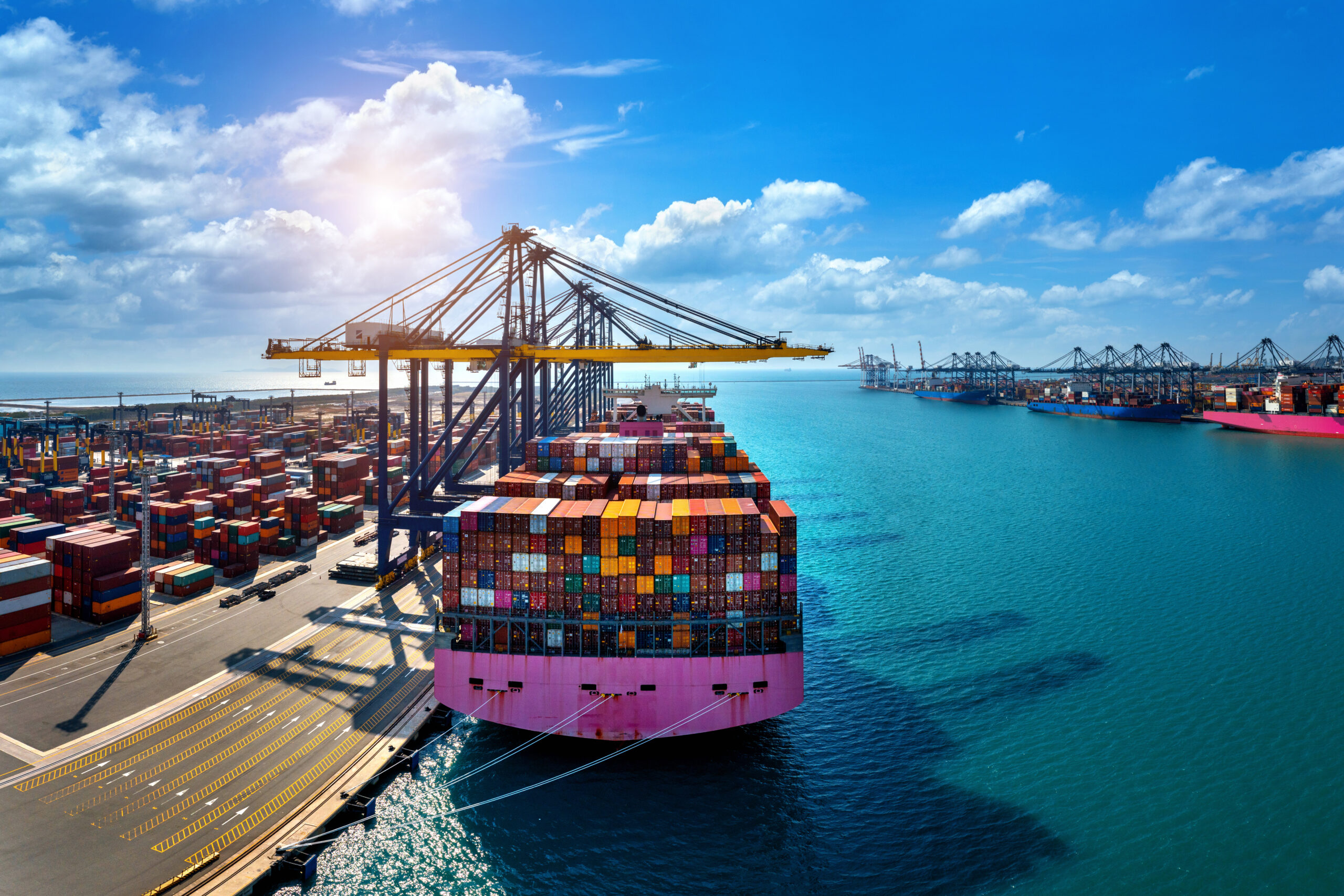 Cargo ship transporting containers across the ocean representing global trade.
